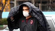 An Iranian man wears protective mask to prevent contracting coronavirus, as he walks in the street in Tehran, Iran February 25, 2020. 