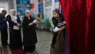 A woman leaves a voting booth to cast her ballot for Tajikistan's parliamentary election at a polling station in Dushanbe on March 1, 2020. AFP / Nozim Kalandarov
 
 