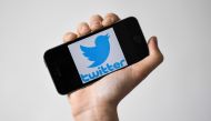 In this file photo taken on May 02, 2019 a woman shows a smartphone with the logo of US social network twitter, in Nantes, western France. twitter said March 4, 2020 it is testing a way for users to 