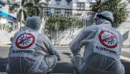 Workers wear hazmat suits as they disinfect and sanitize as a precautionary measure against coronavirus at a public school in the City of San Juan in the Philippines on March 09, 2020. DANTE DIOSINA JR - Anadolu Agency