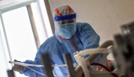 A medical staff member treats a patient infected by the COVID-19 coronavirus at Red Cross Hospital in Wuhan in China's central Hubei province on March 10, 2020.  AFP / STR