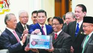 Malaysia's Prime Minister Tan Sri Muhyiddin Yassin (L) launched the COVID-19 relief fund after the first official Cabinet Meeting at the Prime Minister's Office in Putrajaya, Malaysia on March 11, 2020. (Syaiful Redzuan / Anadolu Agency)