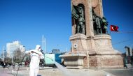  ISTANBUL, TURKEY - MARCH 12: A member of health official, wearing a protective suit, disinfects Taksim Square and Istiklal Street as a precaution to Coronavirus (Covid-19) in Istanbul, Turkey on March 12, 2020. ( Ahmet Bolat - Anadolu Agency ) 