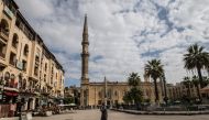 A man walks in the vicinity of the closed al-Hussein mosque in Egypt's capital Cairo on March 20, 2020, after the country's Muslim religious authorities decided to put the Friday prayers on hold, in order to avoid gatherings and the spread of the novel co