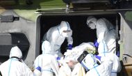 Medical staff install a patient aboard a French medical helicopter NH90 of the 1st RHC near Mercy hospital (CHR Metz), eastern France, to be evacuated to a German hospital in Essen, on March 28, 2020, amid the outbreak of the COVID-19 caused by the novel 