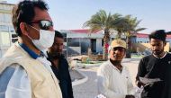 Ramesh Bhata, a leader of Nepalese expatriate community, distributing awareness leaflets in Nepali language among workers in coordination with Qatar Charity.