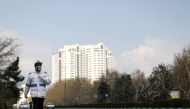A traffic police officer wears a protective face mask and gloves, amid fear of coronavirus disease (COVID-19), as he walks in Tehran, Iran March 26, 2020. WANA (West Asia News Agency)/Ali Khara via Reuters 