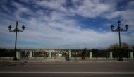A man walks a dog along Segovia street during lockdown, amid the coronavirus disease (COVID-19) outbreak, in Madrid, Spain April 5, 2020. REUTERS/Juan Medina