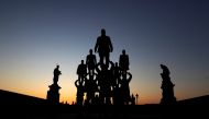 Street artists perform on the medieval Charles Bridge during sunrise as the spread of the coronavirus disease (COVID-19) continues in Prague, Czech Republic, April 2, 2020. REUTERS/David W Cerny