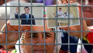 FILE PHOTO: A woman holds pictures of jailed former leader of Turkey's main pro-Kurdish Peoples' Democratic Party Selahattin Demirtas as people gather to celebrate Newroz, which marks the arrival of spring and the new year, in Istanbul, Turkey March 24, 2