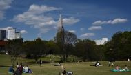 People relax at Meiji park in Tokyo on April 11, 2020. Japan on April 7 declared a month-long state of emergency over a spike in coronavirus cases, ramping up efforts to contain infections but stopping short of the strict lockdowns seen in other parts of 