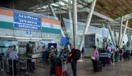 :British nationals queue up outside a departures terminal before boarding a special British Airways flight during Indian government-imposed nationwide lockdown as a preventive measure against the COVID-19 coronavirus, at the Sardar Vallabhbhai Patel Inter
