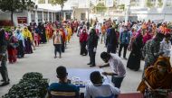  In this file photo taken on April 7, 2020, labourers wait in queues to collect their salary in a garment factory during a government-imposed lockdown as a preventive measure against the COVID-19 coronavirus in Savar, on the outskirts of Dhaka. (AFP / MUN