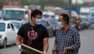 Men wearing face masks walk along a street before curfew, during the global outbreak of the coronavirus disease (COVID-19), in Shubra El Kheima, Al Qalyubia Governorate, north of Cairo, Egypt, April 27, 2020. REUTERS/Mohamed Abd El Ghany