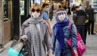 TOPSHOT - Shoppers clad in protective gear, including face masks and shields and latex gloves, due to the COVID-19 coronavirus pandemic, walk through the Tajrish Bazaar in Iran's capital Tehran on April 25, 2020 during the Muslim holy month of Ramadan. / 