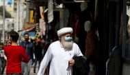 A man wears a protective face mask as he walks along the main market in downtown after the government eased the restrictions on movement aimed at containing the spread of the coronavirus disease (COVID-19), in Amman, Jordan April 29, 2020. REUTERS/Muhamma