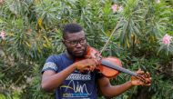 Nigerian Violinist, Peter Oluwadare, 23, who performs at weekly concerts at the isolation center, plays the violin during an interview with Reuters, amid the spread of coronavirus disease (COVID-19) in Lagos, Nigeria April 16, 2020. Picture taken April 16