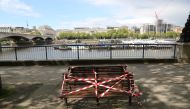 LONDON, UNITED KINGDOM - MAY 1: Benches are covered with tapes to enforce social distancing alongside the Thames River in London, England on May 1. As government prepares to announce an road map to exit strict social distancing precautions next week, toda