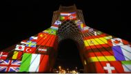 Iran's Azadi (Freedom) Tower is lit up with flags and messages of hope in solidarity with all the countries affected by the COVID-19 coronavirus pandemic, in Tehran on March 31, 2020. / AFP /