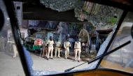 Policemen are seen through a broken windshield of an auto-rickshaw during clashes with police after police urged the residents to remain indoors during an extended lockdown to slow the spreading of the coronavirus disease (COVID-19), in Ahmedabad, India, 