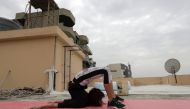 Lebanese gymnast Karen Dib practices on the rooftop of her building, during a lockdown imposed by the autorities in a bid to stem the spread of the novel coronavirus in the town of Halat, north of the capitla Beirut on April 24, 2020. AFP / JOSEPH EID
