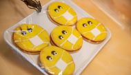 A tray of cookies decorated with faces wearing masks is being placed in the cake stand at the reopened Cafe Prag in Schwerin, northeastern Germany on May 9, 2020 amid the ongoing Covid-19, coronavirus pandemic. AFP / Odd ANDERSEN
