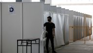 A man wearing a protective face mask is seen at a new medical facility set up for testing migrant workers residing in dormitories for the coronavirus disease (COVID-19), in Singapore May 10, 2020. REUTERS/Edgar Su 