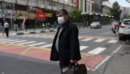 An Iranian man wears a protective face mask, following the outbreak of the coronavirus disease (COVID-19), as he stands in Vali-E-Asr street, in Tehran, Iran, May 20, 2020. 