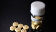 FILE PHOTO: Tablets of Avigan (generic name : Favipiravir), a drug approved as an anti-influenza drug in Japan and developed by drug maker Toyama Chemical Co, a subsidiary of Fujifilm Holdings Co. are displayed during a photo opportunity at Fujifilm's hea