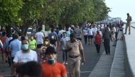 People walk at the sea front after the government eased a lockdown imposed as a preventive measure against the COVID-19 coronavirus, in Mumbai on June 8, 2020.  AFP / Punit PARANJPE
