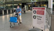 A passenger walks through a terminal at Heathrow Airport, as Britain launches its 14-day quarantine for international arrivals, following the outbreak of the coronavirus disease (COVID-19), London, Britain, June 8, 2020. REUTERS/Toby Melville

