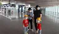 People wearing protective gear are pictured inside the terminal at Beijing's international airport on June 17, 2020. AFP / STR
