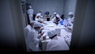 FILE PHOTO: This photo taken on June 10, 2020 shows researchers working in a lab  in China/ AFP / NOEL CELIS / 