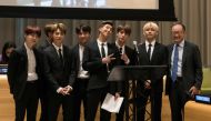  In this file released by the United Nations, K-Pop band BTS poses for a photo with World Bank President Jim Yong Kim (R) during a meeting focused on youth issues at the United Nations in New York on September 24, 2018. AFP PHOTO / UN/ Mark GARTEN