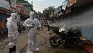 Firefighters wearing Personal Protective Equipment (PPE) spray disinfectant in a closed market amid concerns over the spread of the COVID-19 coronavirus in Siliguri on June 22, 2020. AFP / Diptendu Dutta 