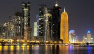 The file picture shows a night view of Qatar's evolving new skyline .