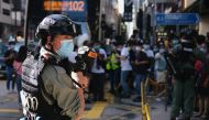 A riot police officer holds a pepper-spray projectile as he stands guard to avoid mass gathering during a protest against the looming national security legislation in Hong Kong, China June 28, 2020. REUTERS/Tyrone Siu

