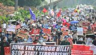 This file photo was taken on June 4, 2020, shows mask-clad protesters marching against an anti-terrorism bill at a university campus in Manila. / AFP / Ted ALJIBE
