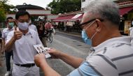 Singapore's Deputy Prime Minister Heng Swee Keat (L), of the incumbent People's Action Party, gives a thumbs up during a campaign walkabout in the Bedok South estate neighbourhood ahead of the general election in Singapore on July 8, 2020. / AFP / ROSLAN 