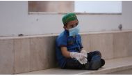 A child who suffers from cancer sits in a corridor at the Children's Hospital for Cancer Diseases, amid the spread of the coronavirus disease (COVID-19), in Basra, Iraq July 9, 2020. Picture taken July 9, 2020. REUTERS/Essam Al-Sudani