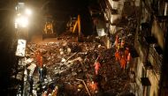 National Disaster Response Force (NDRF) and fire brigade personnel look for survivors trapped in the debris after part of a residential building collapsed following heavy rains in Mumbai, India, July 16, 2020. REUTERS/Francis Mascarenhas