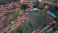 An aerial view shows flooded residential buildings due to rising water levels of the Yangtze river in Jiujiang, China's central Jiangxi province, on July 18, 2020. / AFP / Hector RETAMAL