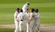 England's Jos Buttler celebrates with teammates after winning the test, as play resumes behind closed doors following the outbreak of the coronavirus disease (COVID-19) Jon Super/Pool via REUTERS