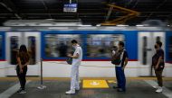 Passengers wearing face masks for protection against the coronavirus disease (COVID-19) maintain social distancing while queuing to ride a train in Quezon City, Metro Manila, Philippines, July 21, 2020. REUTERS/Eloisa Lopez