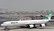 (FILES) In this file photo taken on September 14, 2017, an Iranian airliner Mahan Air Airbus A340 aircraft is seen at the tarmac at Dubai International Airport. AFP / GIUSEPPE CACACE