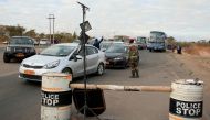 Police and soldiers check on motorists at a roadblock during the coronavirus disease (COVID-19) outbreak in Harare, Zimbabwe, July 24, 2020. REUTERS/Philimon Bulawayo