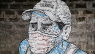 A mural of a man wearing a mask is pictured on a sidewalk amid the coronavirus disease (COVID-19) outbreak in Quezon City, Metro Manila, Philippines, July 30, 2020. REUTERS/Eloisa Lopez NO RESALES. NO ARCHIVES.