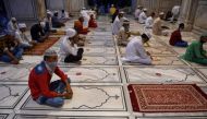 Muslim devotees wait to offer a special morning prayer to kick off the Eid al-Adha, the feast of sacrifice, at Jama Masjid mosque in New Delhi on August 1, 2020. / AFP / Money SHARMA
