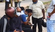 Relatives of the victims of an accident where a crane collapsed after its cabin and base snapped during a trial run, react at a hospital in Visakhapatnam on August 1, 2020. / AFP / STR
