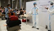 Passengers queue to be tested for COVID-19 on arrival at Charles de Gaulle airport amid the coronavirus disease (COVID-19) outbreak, in Roissy, near Paris, France July 31, 2020. REUTERS/Christian Hartmann